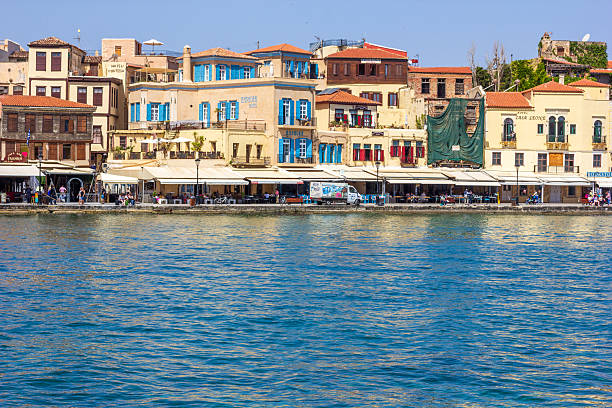 Many people and stores visible on Chania Harbour on Crete, Greece
