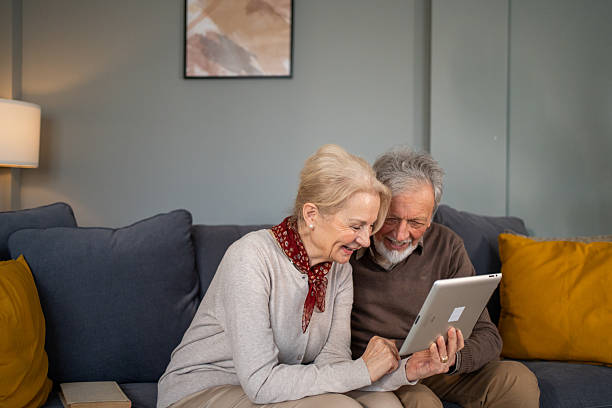 istock Happy senior couple using digital tablet at home 2214235896