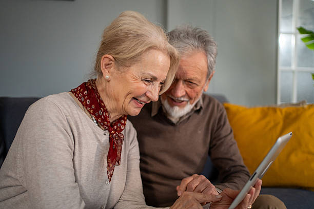 istock Happy senior couple using digital tablet at home 2214235908
