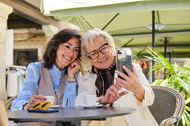 istock Senior women taking selfie while drinking coffee in barcelona 2214236618
