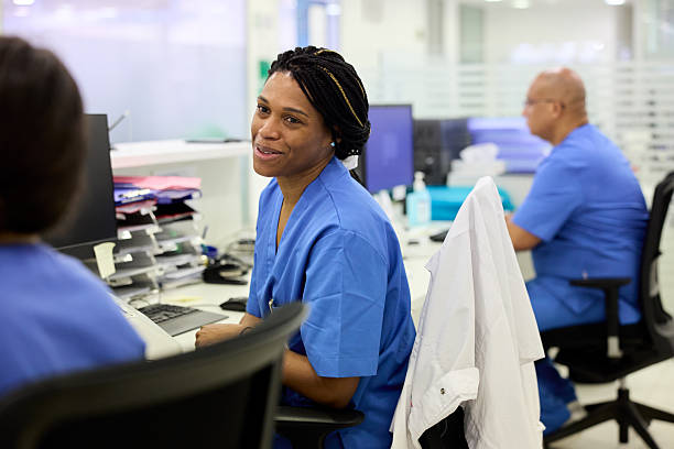 istock Nurses chatting on a break from work at the hospital's reception area. 2214239806