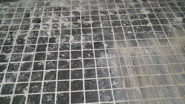 istock Cleaning dust and dirt from black mosaic tile floor during renovation 2214240523