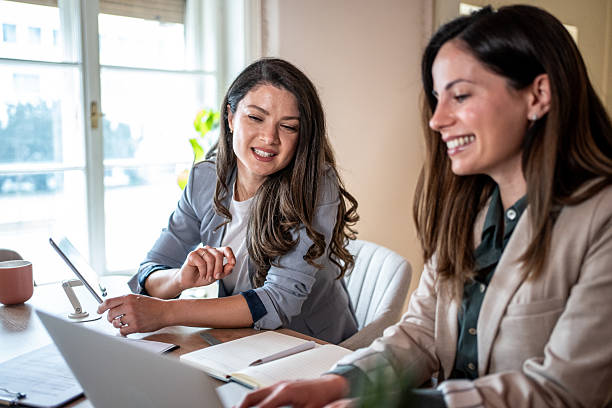 istock Two businesswomen collaborating on a project using laptop and tablet 2214242136