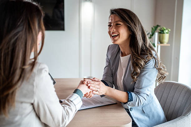 istock Two businesswomen shaking hands after signing contract 2214242285