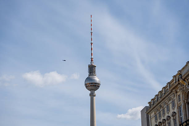 Berlin TV Tower against the blue sky. Helicopter flying over Berlin TV Tower.