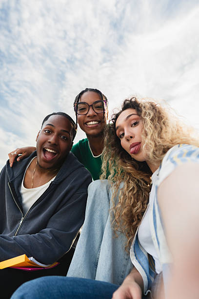 istock Group of students taking a selfie outdoors 2214245429