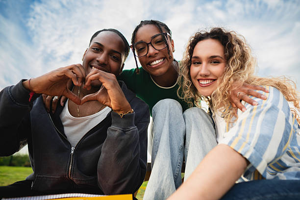 istock Happy multi-ethnic students making heart shape with hands, smiling at camera 2214245446