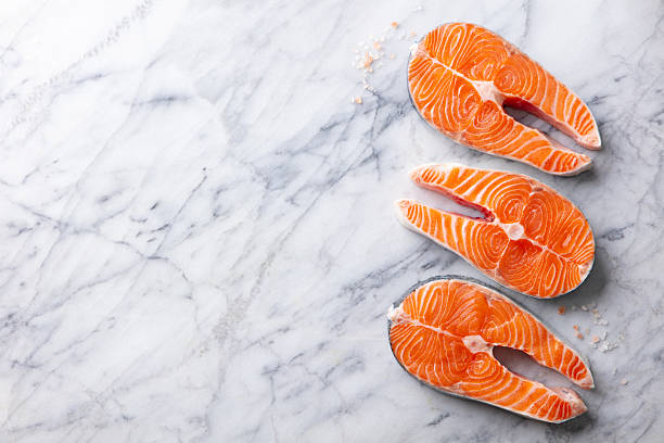 Salmon steaks, fillet. White marble background. Copy space. Top view.
