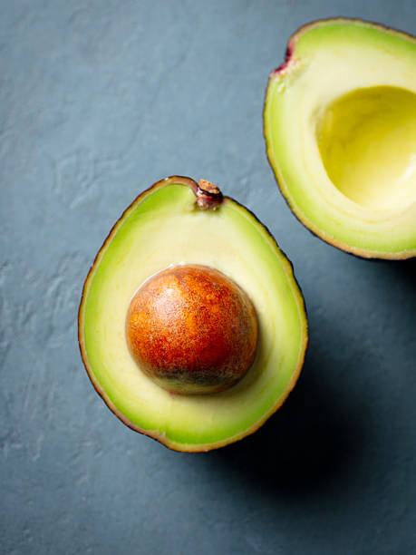 istock Half an avocado on the table. Grey stone background. Top view. 2214247006