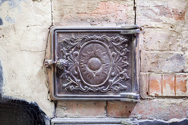 istock Intricate Decorative Cast Iron Cover on an Old Brick Wall in an Urban Setting Showcasing Vintage Craftsmanship and Architectural History 2214248928