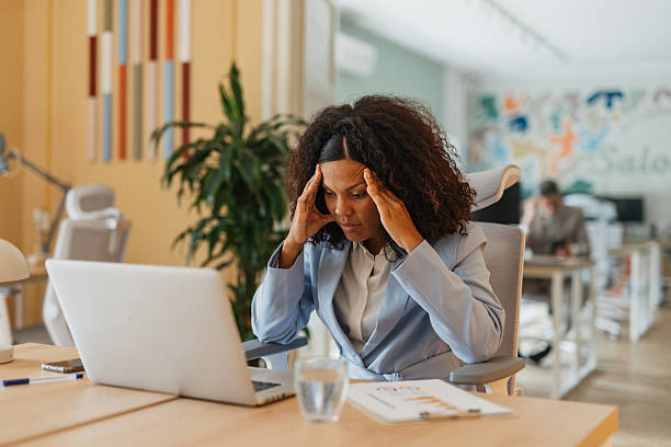 istock Stressed professional woman at her workstation 2214249132