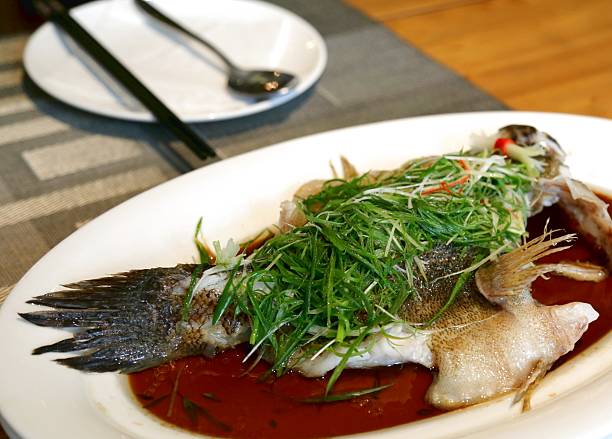 istock Steamed fish chinese cuisine cantonese style dish closeup view 2214250301