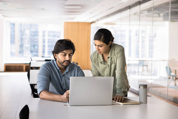istock Two Indian business partners meeting at workplace table 2214250406