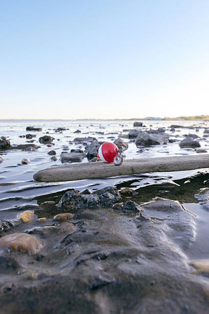 Bobber detached in the middle of the shoreline with a hook connected