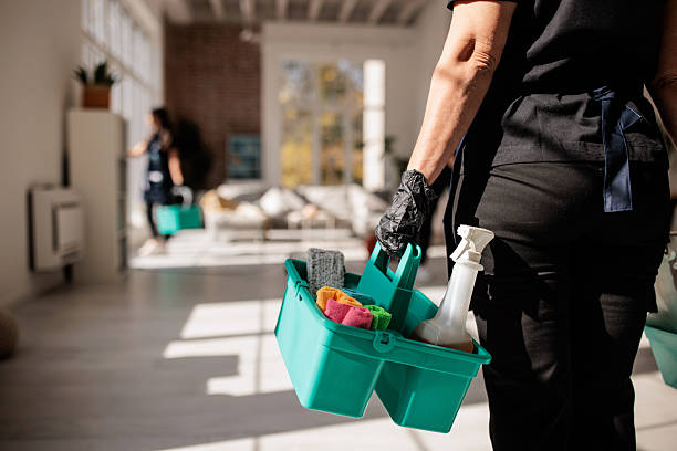 Professional Cleaner Carrying Cleaning Supplies