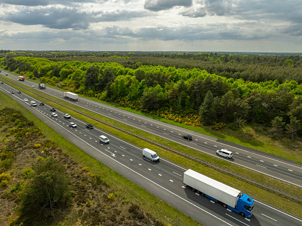 istock Semi truck driving on a highway through nature 2214253151