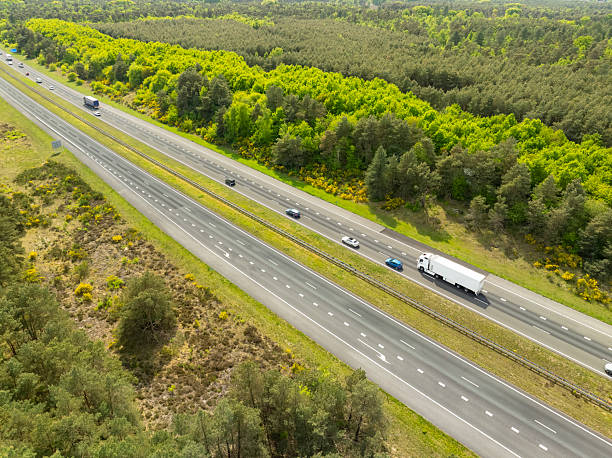 istock Semi truck driving on a highway through nature 2214253201