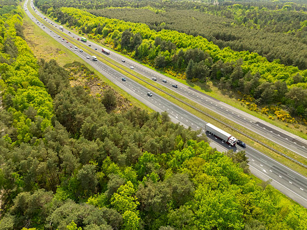 istock Semi truck driving on a highway through nature 2214253245