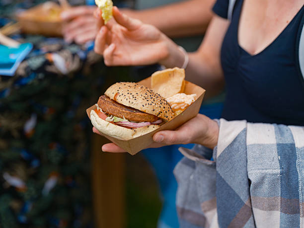 istock Person Holding Plant-Based Burger in Eco-Friendly Container 2214254109