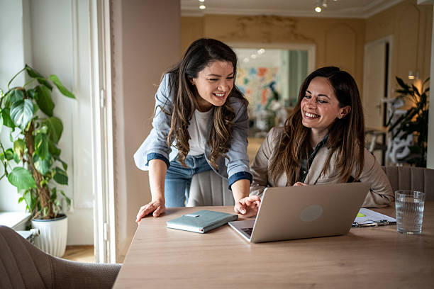istock Two businesswomen collaborating on a laptop in a modern office 2214256026