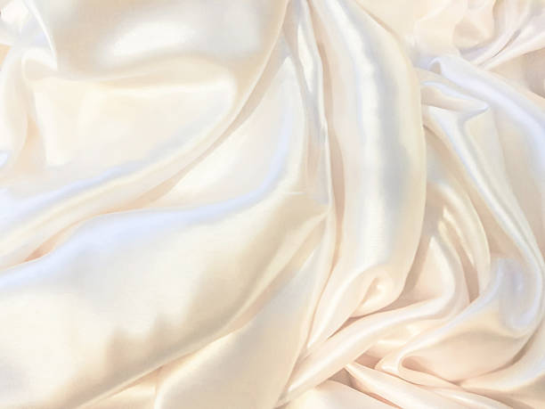 istock Golden silk fabric, smooth and shiny, luxurious. 2214256226
