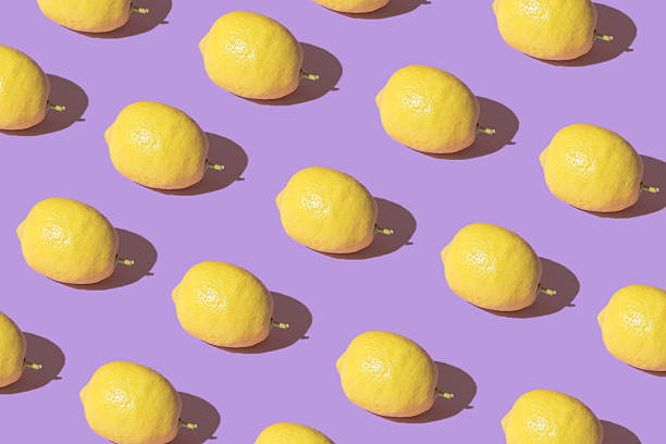 istock Trendy sunlight Summer pattern mad with yellow lemon on bright purple backround.Minimal summer concept 2214257102