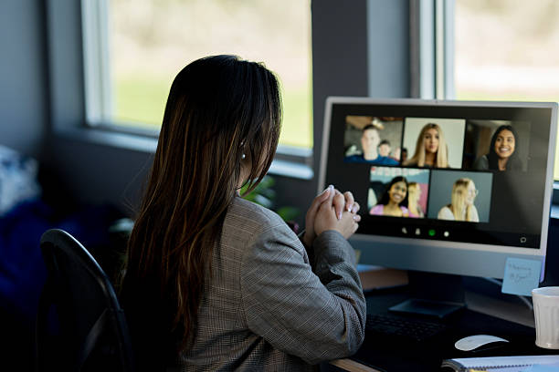 istock Professional Woman Engaged in Video Call with Diverse Participants 2214257387