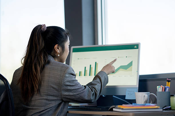 istock Businesswoman Analyzing Financial Data on a Desktop Computer in an Office Setting 2214257408