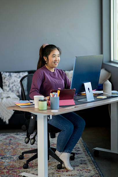 istock Young Woman Working in a Bright and Organized Home Office Setup 2214257511