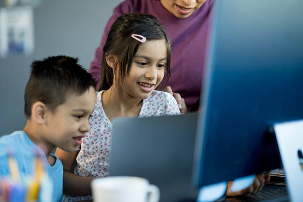 istock Teacher Encouraging Children to Learn During a Fun Group Activity in Classroom 2214258144