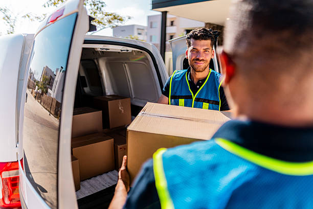 istock Delivery men unpacking van outdoors 2214259880