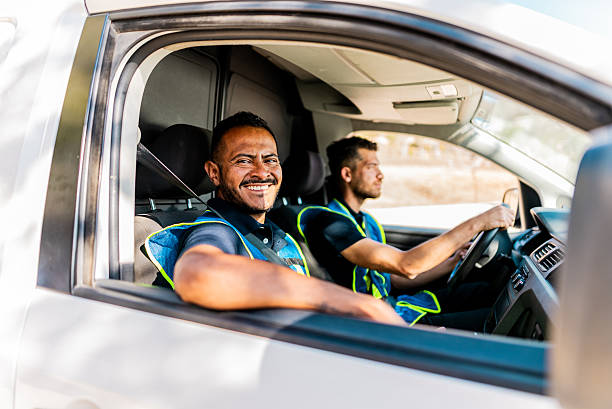 istock Portrait of young delivery man inside van 2214259938