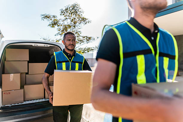 istock Delivery men unpacking van outdoors 2214260034