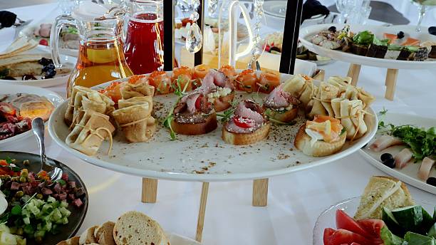 istock Gourmet appetizer spread featuring golden pancakes, delicate canapes, and assorted culinary delights arranged with artistic precision on elegant tabletop 2214262603