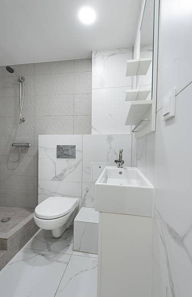 istock Modern Bathroom Interior With Marble Tiles and Compact Functional Fixtures 2214262704