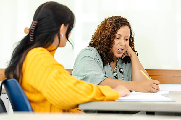 istock Teacher and Student Discussing Ideas in Classroom 2214263340