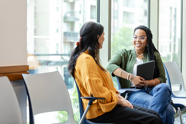 istock Two Diverse Women in Casual Clothing Having a Discussion 2214263368