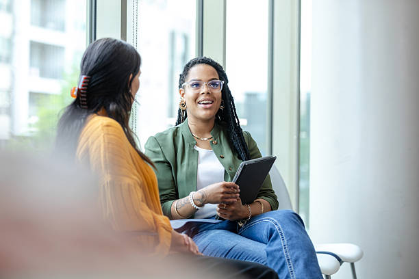 istock Two Women in Casual Clothing Having a Discussion 2214263402