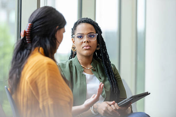 istock Two Women in Casual Clothes Having a Discussion 2214263403