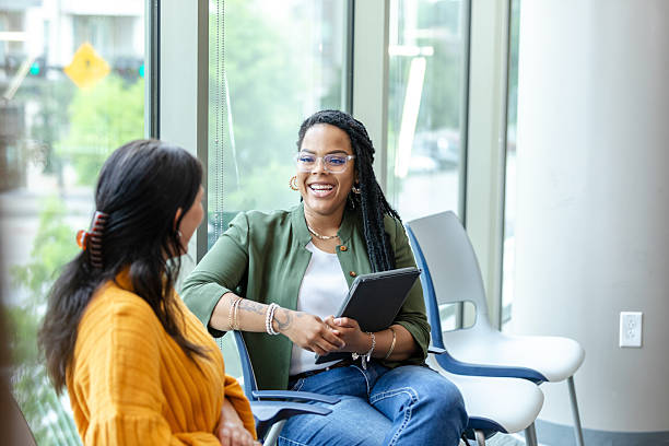 istock Two Women Having a Discussion in a Modern Office 2214263407