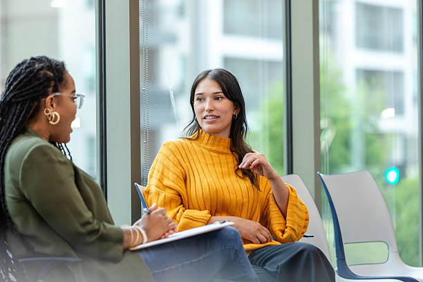 istock Two Women in Casual Clothing Having a Discussion 2214263409