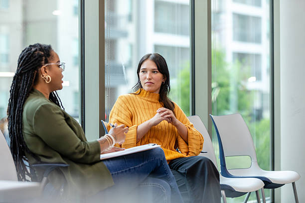 istock Two Women in Casual Clothing Having a Discussion 2214263413