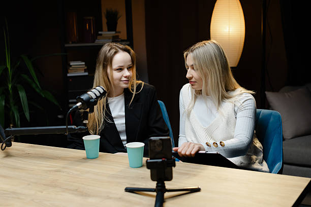 istock Podcasters recording live show using microphone and smartphone 2214264183
