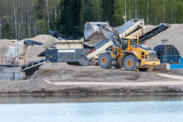 Sand Quarry Operations by the Water. Industrial Sand Excavation in Nature Setting