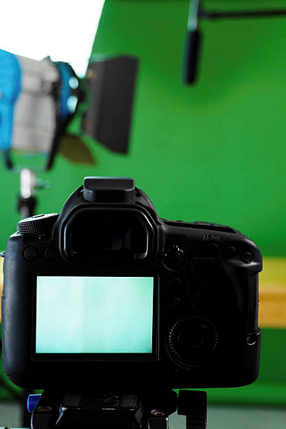 istock Professional dslr camera recording with green screen background and studio lights 2214267256