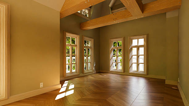 istock Empty room with parquet flooring and exposed beams illuminated by sunlight 2214272071