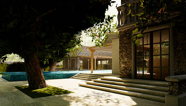 Terrace of a villa where you can see the swimming pool and the background stone wall of it