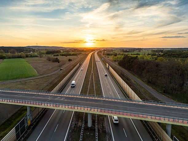 istock Road Bridge Casting Long Shadows at Dusk 2214272234