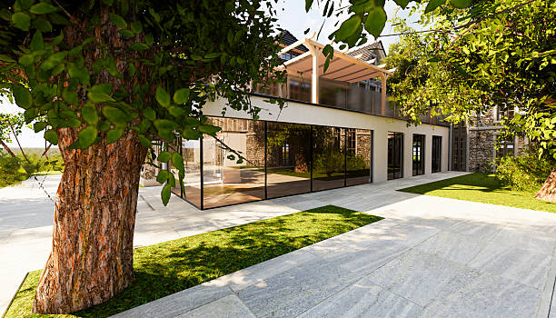 istock Modern house with glass windows and big tree 2214272280