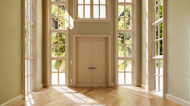 istock Sun shining through large windows in empty room with parquet floor 2214272334